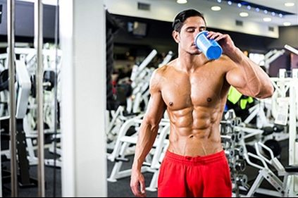 Bodybuilder having a protein shake